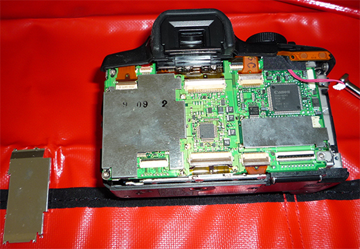 De-soldering the shield in front of the circuit board.