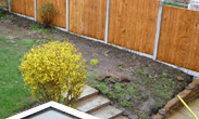 After replacing the fence and garden steps. Rockery removed and retaining sandstone wall constructed.