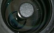 Dust particles on the meniscus lens.